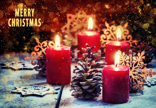 Red burning candles with pine cones and snowflakes  - Foto, Bild