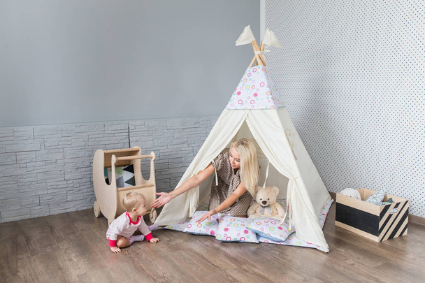Parents with children in a teepee - Photo, image