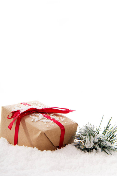 Christmas presents in brown paper with red ribbon - Photo, Image