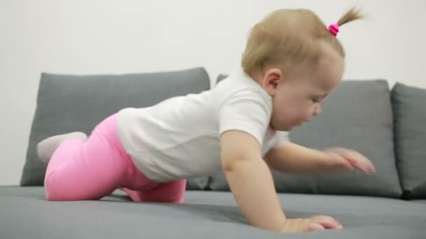 little girl playing on the couch at the living room - Záběry, video