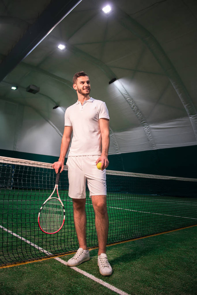 Delighted handsome tennis player going to play - Фото, зображення
