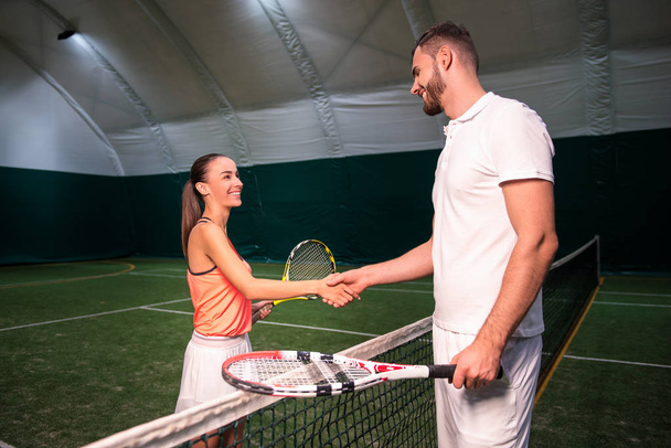 Positive tennis players shaking hands - Photo, image