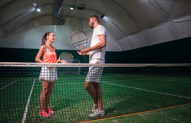 Positive smiling professioanl tennis players talking - Zdjęcie, obraz
