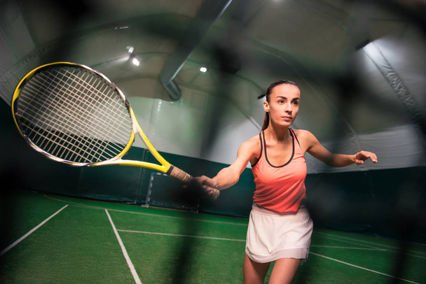 Serious young woman playing tennis - Fotoğraf, Görsel