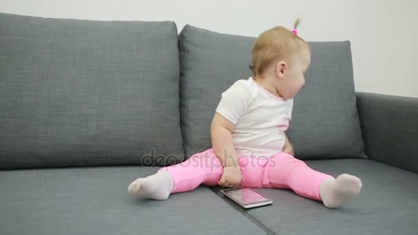 little girl playing on the couch at the living room - Video