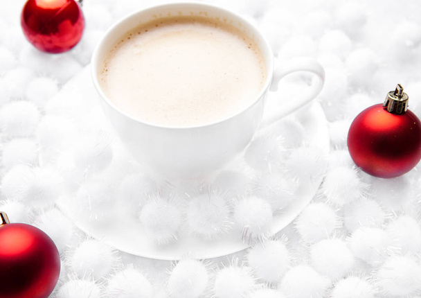 Cup of cappuccino coffee on snow christmas balls - Photo, Image