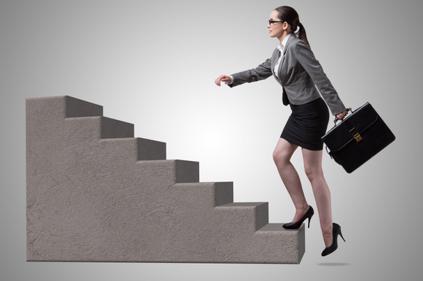 Businesswoman climbing career ladder concept - Foto, imagen