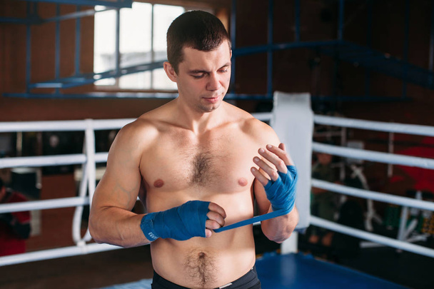 Boxer pulling blue bandage - 写真・画像