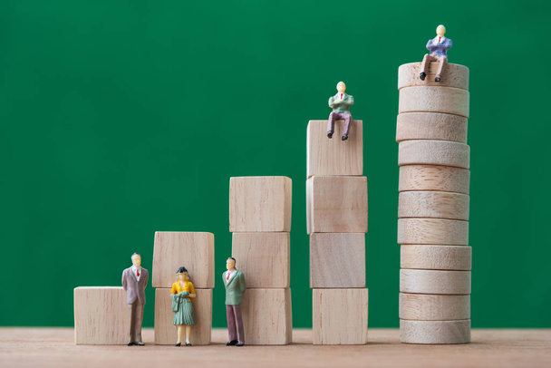 stack of wood cube building blocks and miniature people - Photo, image