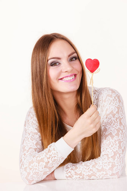 Beautiful woman holding heart shaped hand stick - Φωτογραφία, εικόνα