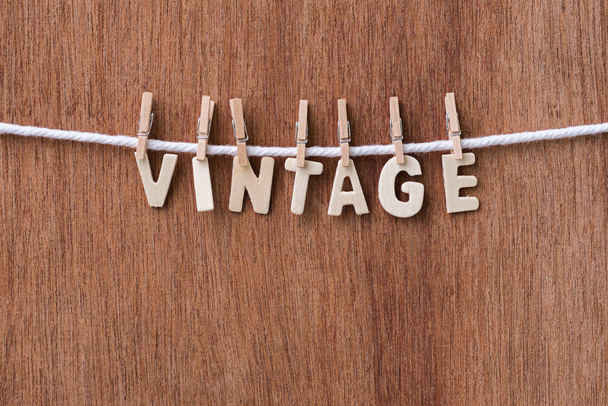 wood text VINTAGE hanging with clothespins  - Photo, image