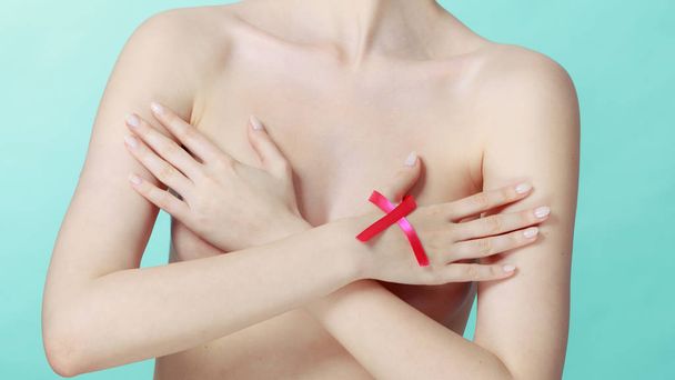 Naked woman with breast cancer awareness ribbon - Fotoğraf, Görsel