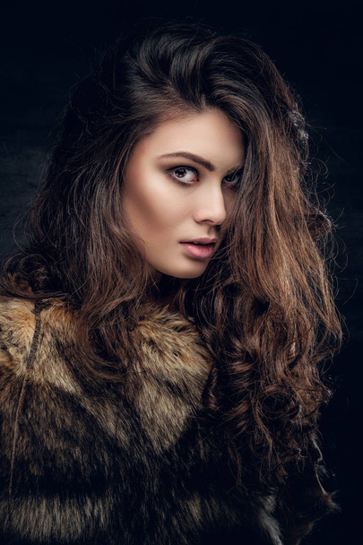 Brunette woman dressed in a fur coat - Photo, Image