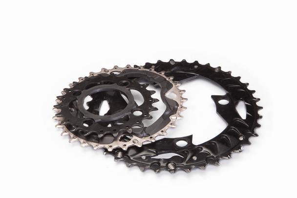 Three bicycle chainwheels and chainring on a white - Fotó, kép