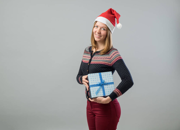 Young woman hold christmas gift - Фото, изображение