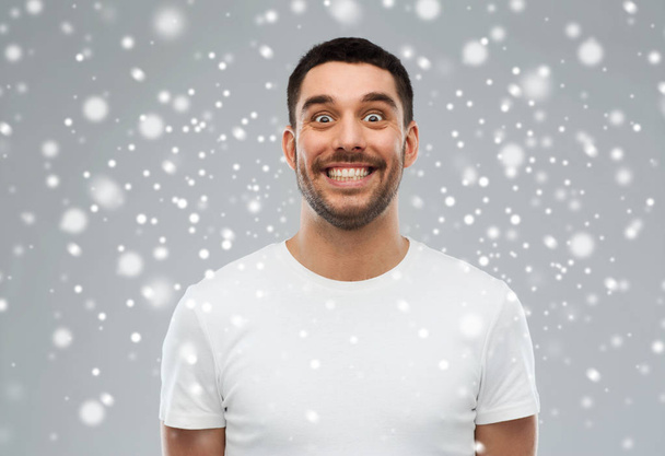 man with funny face over snow - Fotoğraf, Görsel