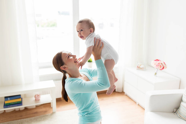 happy young mother with little baby at home - 写真・画像