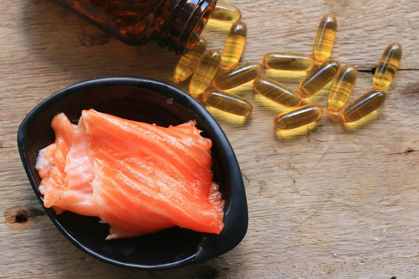 fish oil capsules and salmon - Photo, Image