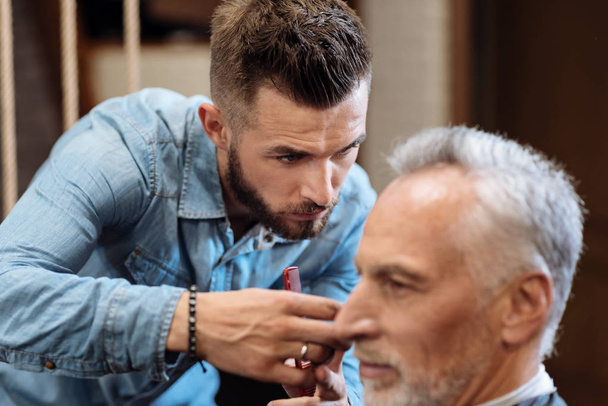 Close up of young male hairdresser cutting hair - Fotografie, Obrázek
