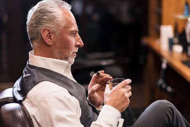 Man sitting with cognac glass and cigar - Фото, изображение