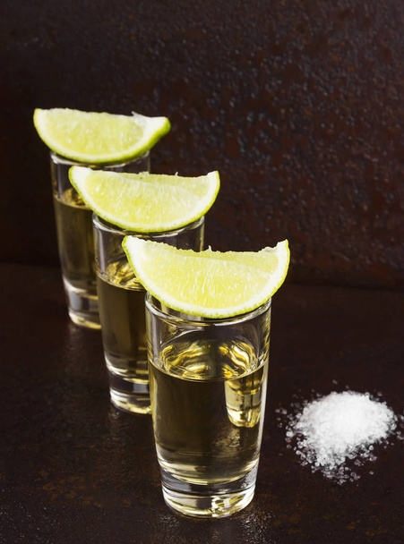 Tequila with salt and lime on a dark background - Foto, immagini