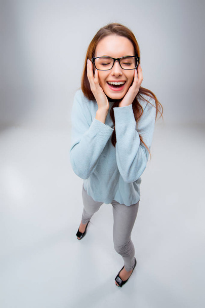 The smiling young business woman on gray background - Foto, immagini