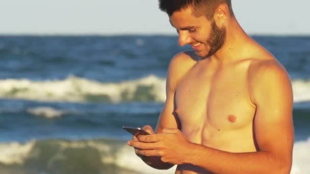 Handsome man with smart phone always keeping in touch - Filmagem, Vídeo