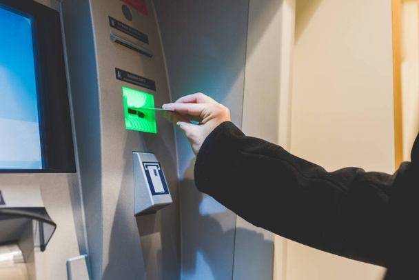 hand inserting debit card in ATM machine - Фото, зображення