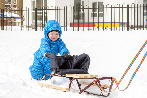 Young mother and little boy enjoying sleigh ride. Child sledding. Toddler kid riding sledge. Children play outdoors in snow. Kids sled in snowy park. Outdoor winter fun for family Christmas vacation - Photo, Image