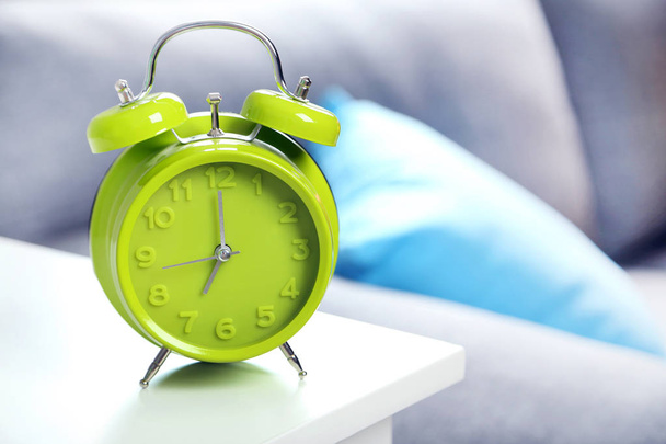 Green alarm clock on  table - Фото, изображение