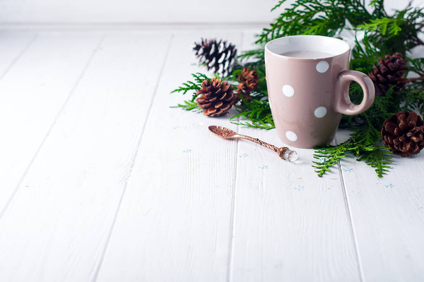 vintage Cup of hot cocoa on wooden background decorated with spruce and pine cones, - Photo, Image