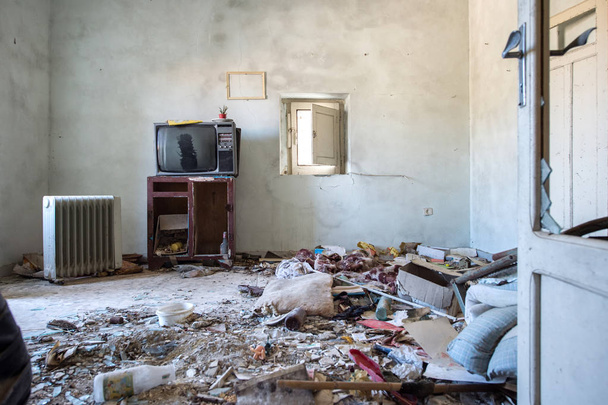 Room destroyed with furniture and old television - Photo, Image