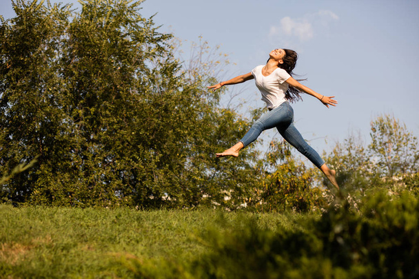 woman jumping with joy barefoot - Foto, Imagem