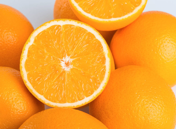 Fresh orange and cut in half on white background  - Foto, Bild