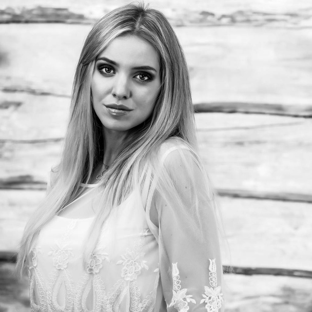 Young sensual & beauty blonde woman pose on wooden background. Black-white photo - Fotografie, Obrázek