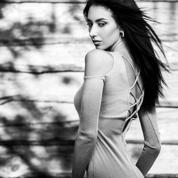 Young sensual & beauty brunette woman pose against wooden background. Black-white photo. - Fotó, kép