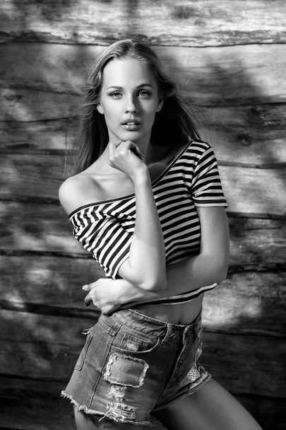 Young sensual & beauty blonde woman pose on wooden background. Black-white photo. - Fotografie, Obrázek