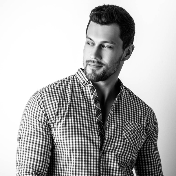Black-white portrait of elegant sporty young handsome man in stylish shirt. - Photo, image