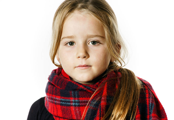 Cute little girl dressing by red comfort scarf - 写真・画像