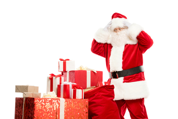 Santa Claus with pile of Christmas gifts - Фото, зображення