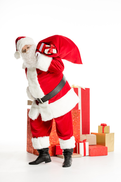Santa Claus with pile of Christmas gifts - Foto, Imagen