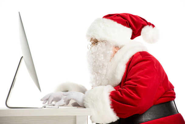 Santa Claus using computer - Фото, зображення