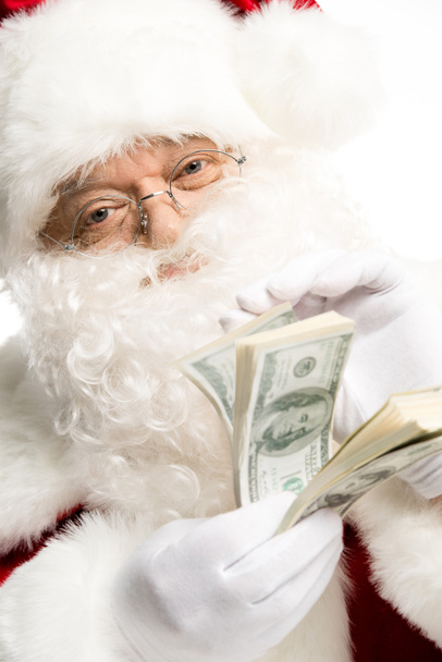 Santa Claus counting dollars  - Фото, изображение