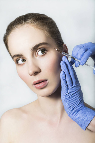 Doctor aesthetician makes face beauty injections to female patient - Zdjęcie, obraz