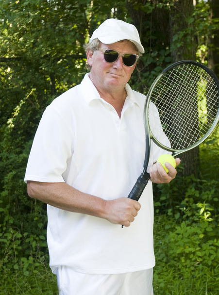 middle age senior tennis player male demonstating stroke - Foto, immagini