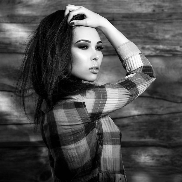 Young sensual & beauty brunette woman pose on wooden background. Black-white photo. - Fotoğraf, Görsel