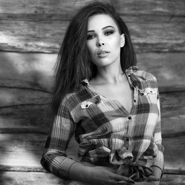 Young sensual & beauty brunette woman pose on wooden background. Black-white photo. - Zdjęcie, obraz