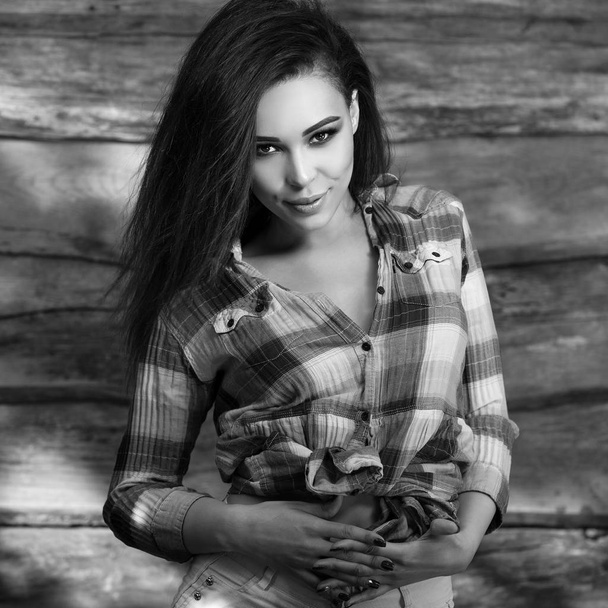Young sensual & beauty brunette woman pose on wooden background. Black-white photo. - Zdjęcie, obraz