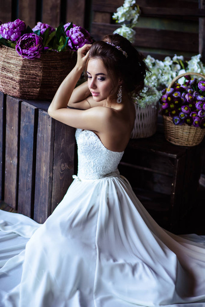 Gorgeous bride young woman in a wedding dress with perfect makeup and hairstyle - Fotó, kép