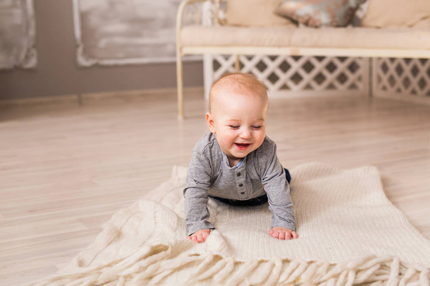 Laughing Baby Boy Lying On Tummy At Home - Photo, Image